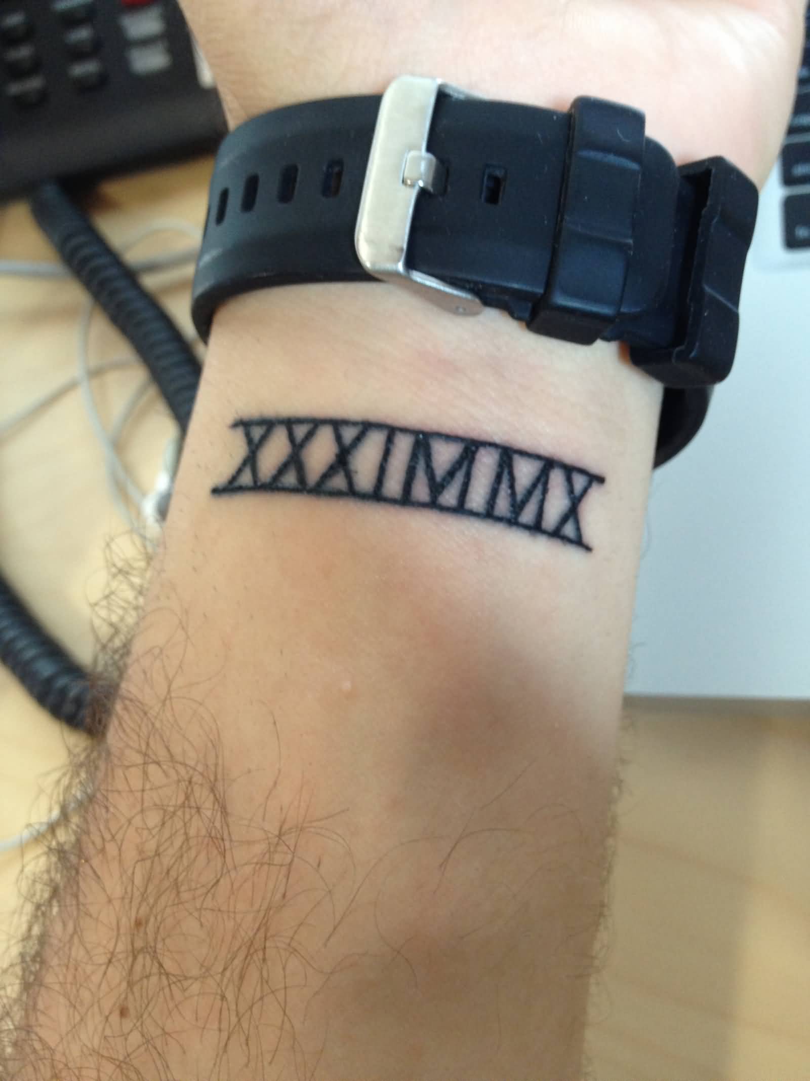 Dark Black Roman Numeral Tattoo On Wrist