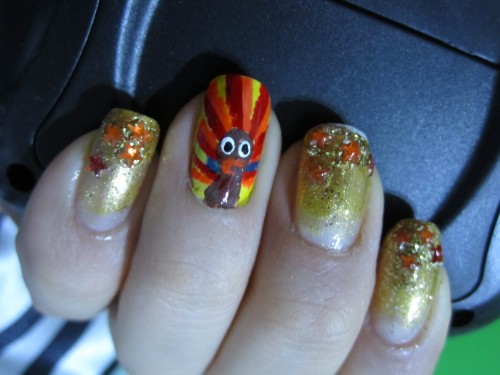Gold Nails With Rhinestones And Accent Turkey Face Thanksgiving Nail Art