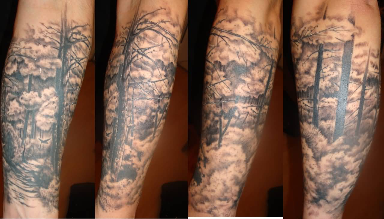 Grey Clouds And Forest Tattoo On Arm