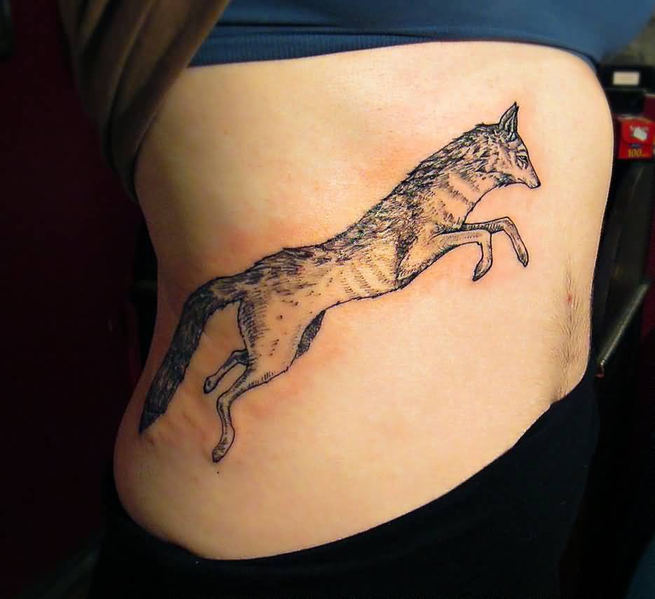 Jumping Coyote Tattoo On Girl Side Rib