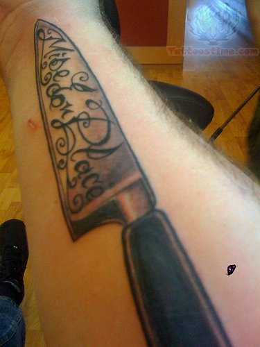Large Chef Knife With Lettering Traditional Tattoo On Forearm