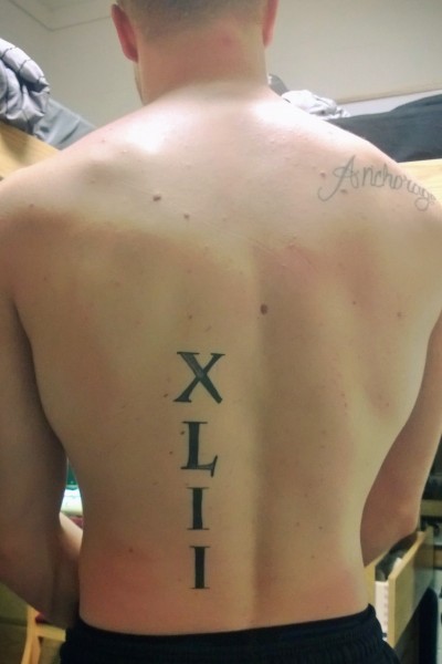 Large Roman Numerals Tattoo On Lower Back