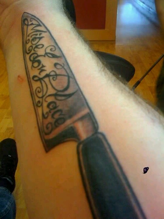 Lettering On Chef Knife Tattoo On Forearm