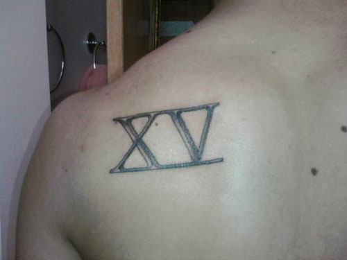 Nice Fifteen Roman Numeral Tattoo On Back Shoulder