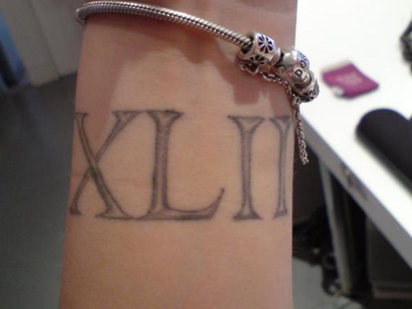 Nice Roman Numeral Tattoo On Wrist By Gerry Carnelly Octopus