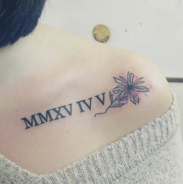 Nice Roman Numerals With Flower Tattoo On Upper Back