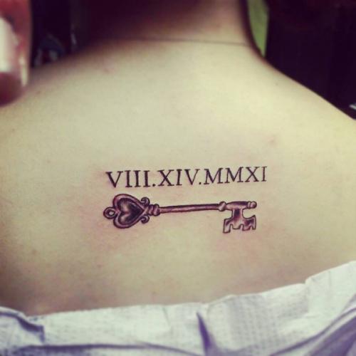 Nice Traditional Roman Numeral Date With Key Tattoo On Upper Back