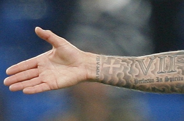 Nicely Designed Roman Numerals Seven With Cross And Lettering Tattoo On Forearm