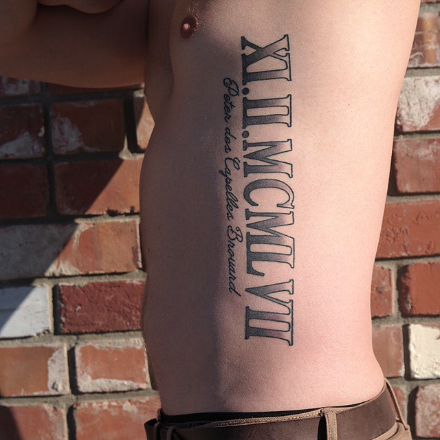 Outstanding Roman Numerals With Lettering Tattoo On Side Rib For Men