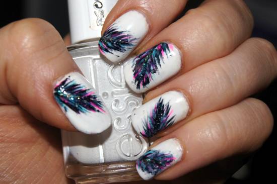 Pink And Blue Feather Nail Art On White Nails