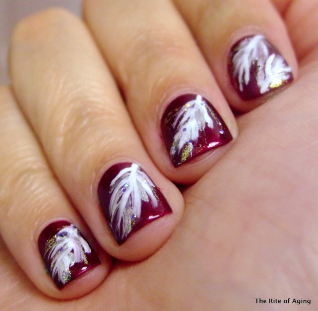 Red Nails With White Feather Nail Art
