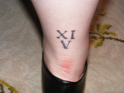 Roman Numeral Eleven And Five Tattoo On Back Leg