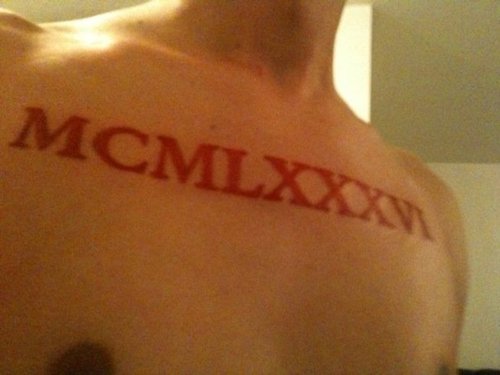 Roman Numerals In Red Color Tattoo On Chest For Men