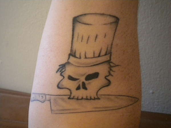 Simple Chef Skull Holding Knife With Mouth Tattoo