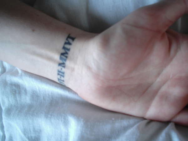 Small Black Color Roman Numeral Tattoo On Wrist