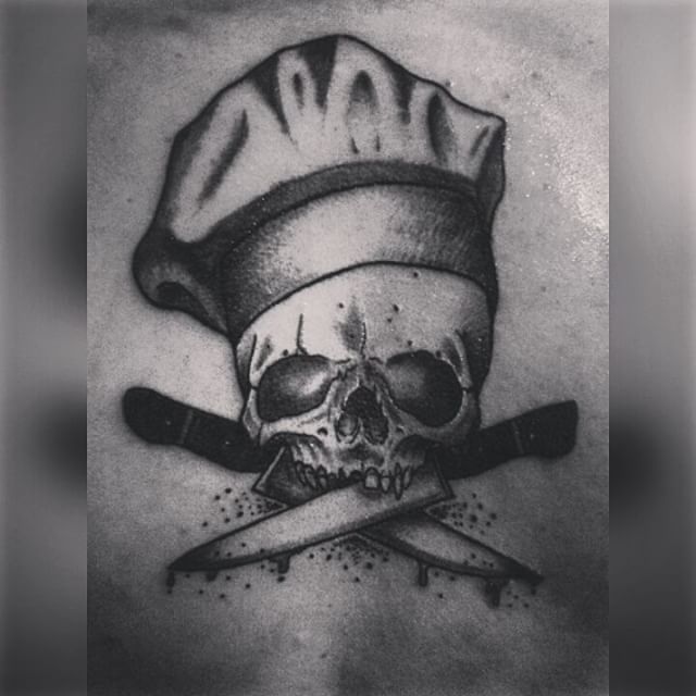 Small Chef Skull Holding Knives With Mouth Tattoo
