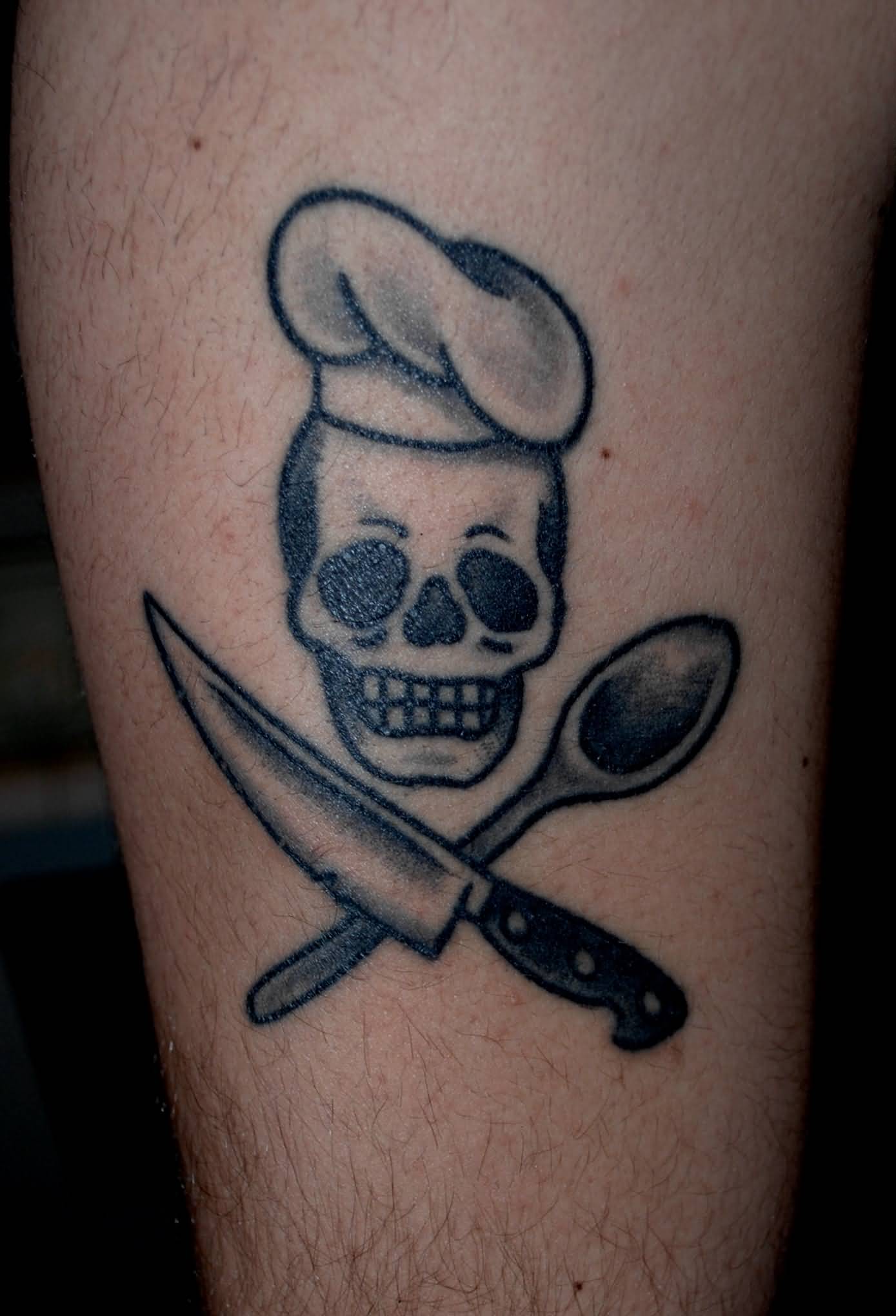 Small Chef Skull With Crossed Spoon And Knife Tattoo
