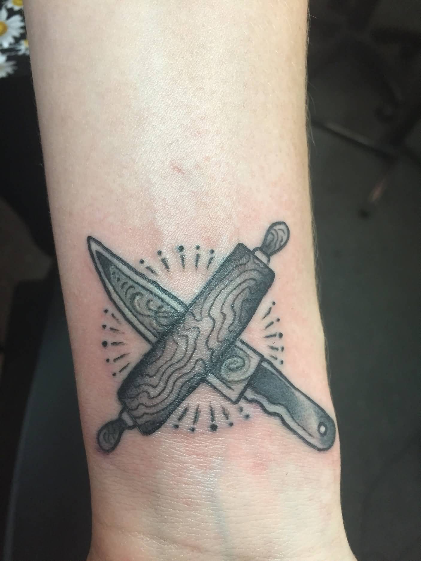 Small Knife With Rolling Pin Tattoo On Wrist