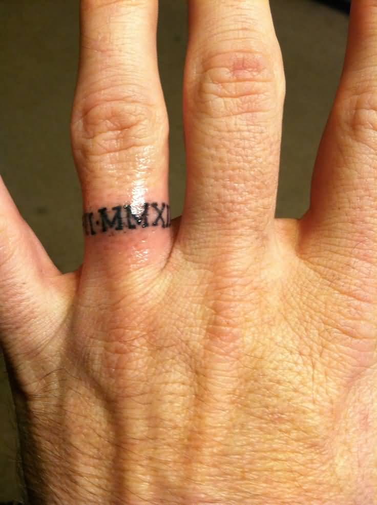 Small Roman Numerals In Ring Shape Tattoo On Finger