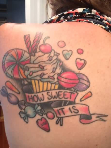 Sweet Pastry With How Sweet It Is On Banner With Candy Tattoo On Upper Back