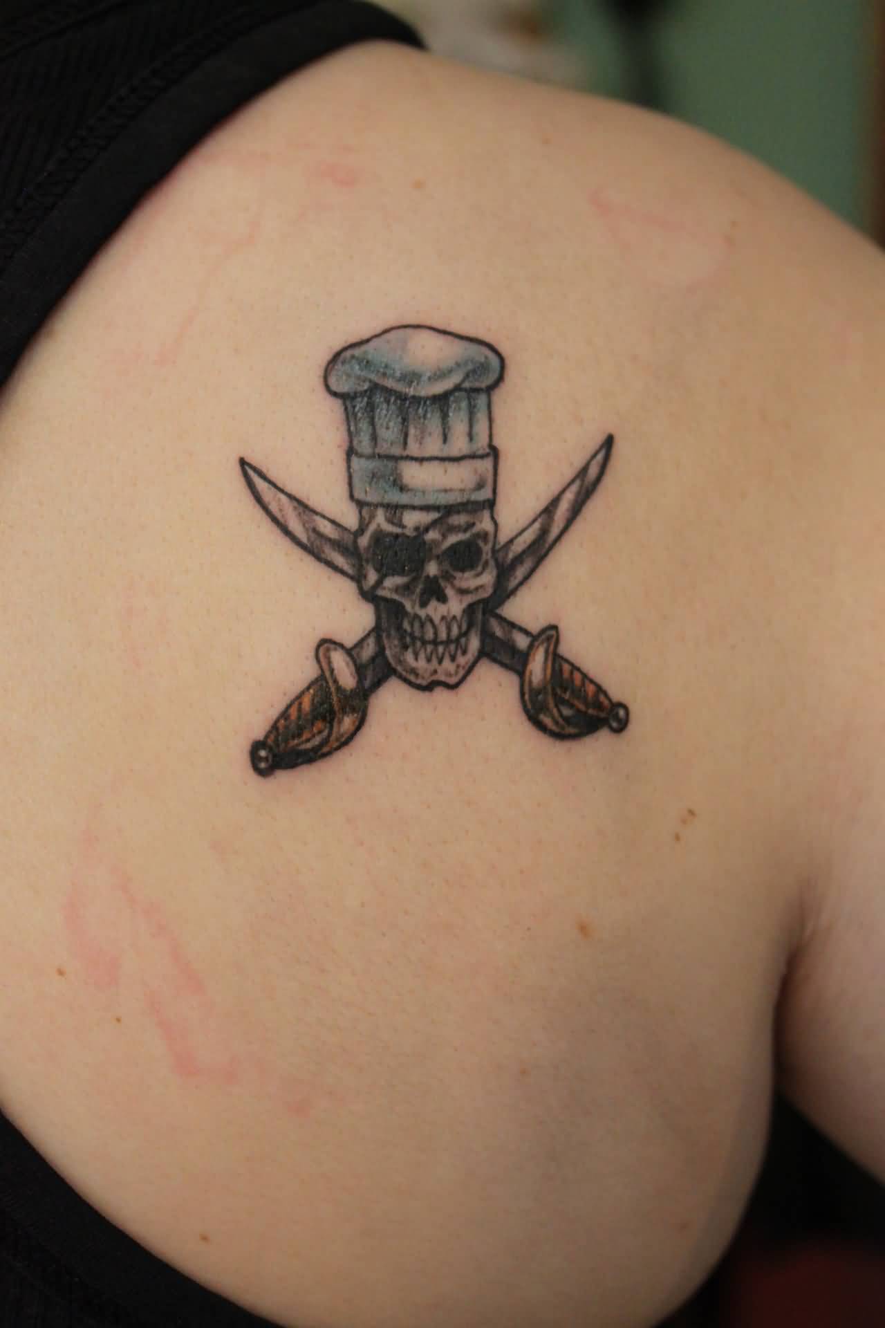 Tiny Chef Skull With Crossed Swords Tattoo On Right Back Shoulder