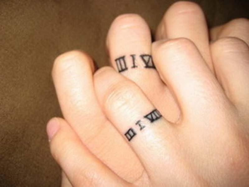 Tiny Matching Roman Numerals Tattoo On Fingers