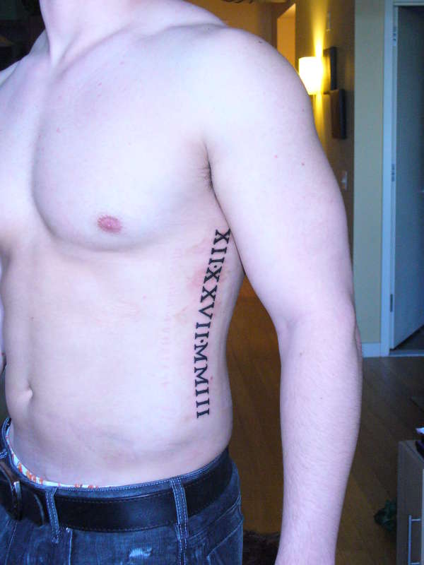 Very Beautiful Roman Numerals Tattoo On Side Rib For Men