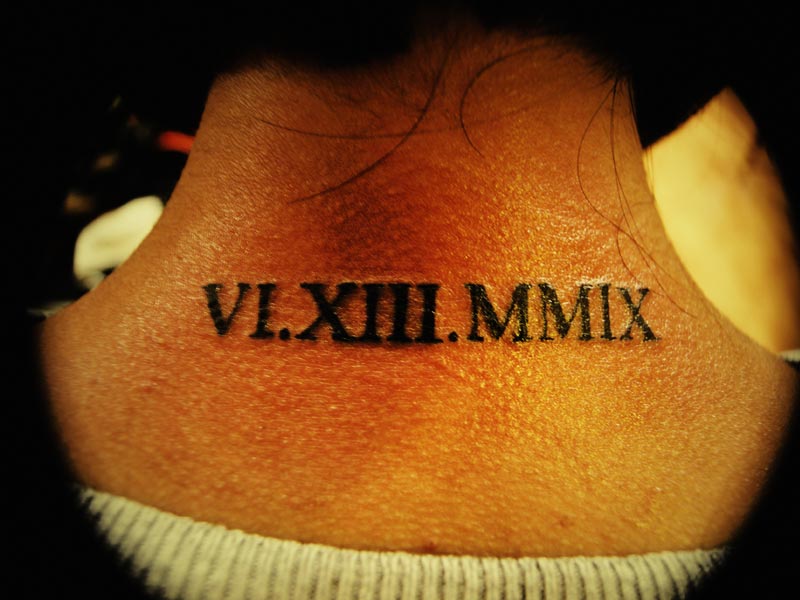 Very Nice Roman Numerals Tattoo On Back Neck