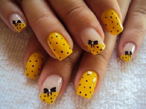 Yellow Nails With Black Polka Dots And Bow Design