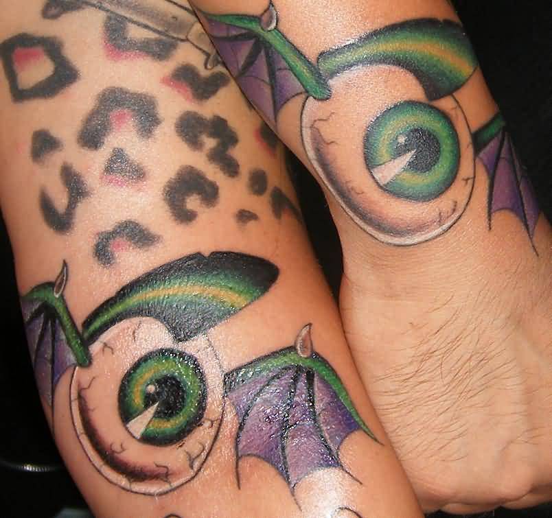 Amazing Eyeball Having Bat Wings Matching Tattoos On Wrists