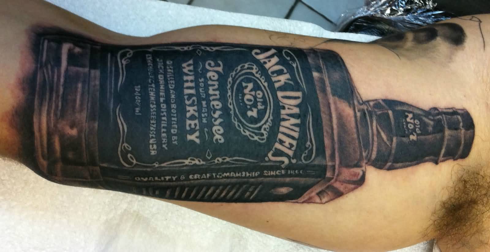 Black And Grey Jack Daniel Bottle Tattoo On Bicep