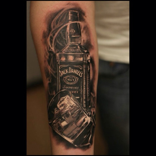 Black And Grey Jack Daniel Bottle With Glass Tattoo On Forearm