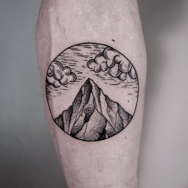Black And Grey Mountain With Clouds In Circle Tattoo On Forearm