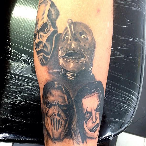 Black And Grey Slipknot Members Heads Tattoo