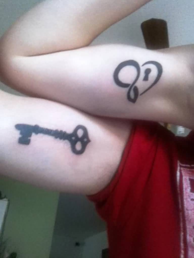 Black Color Lock And Key Heart Matching Tattoos On Biceps