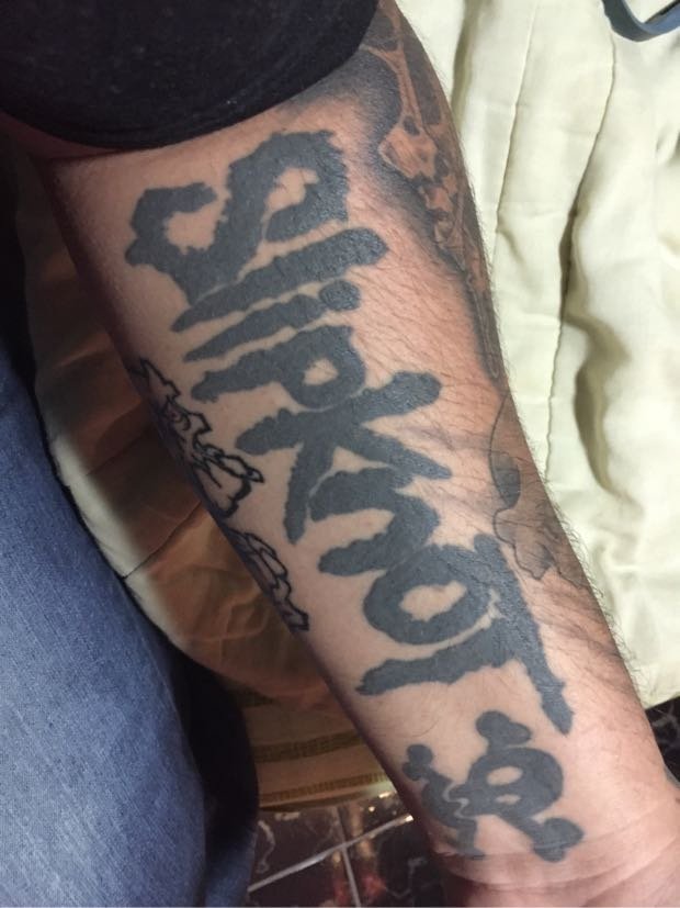 Black Color Slipknot Word Tattoo On Forearm