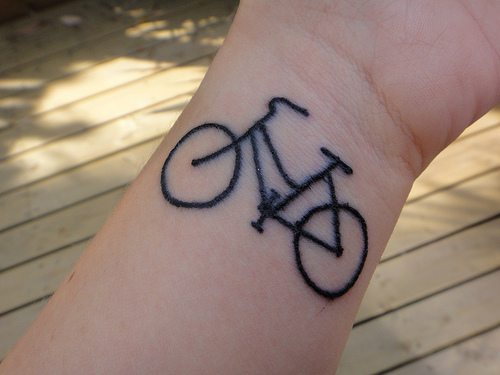 Black Ink Small Cycle Outline Tattoo On Wrist