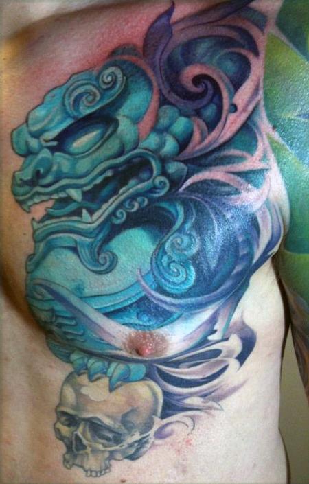 Blue Color Chinese Foo Dog With Skull Tattoo On Chest