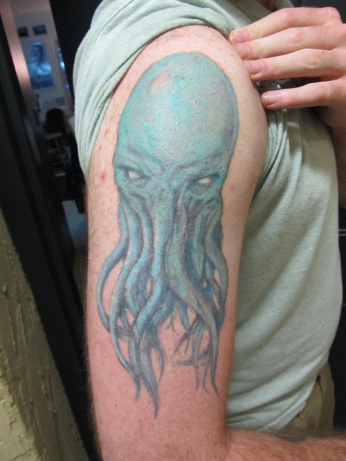 Blue Ink Cthulhu Tattoo On Right Half Sleeve