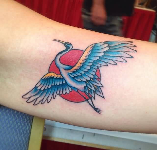 Blue Ink Flying Crane Tattoo On Bicep