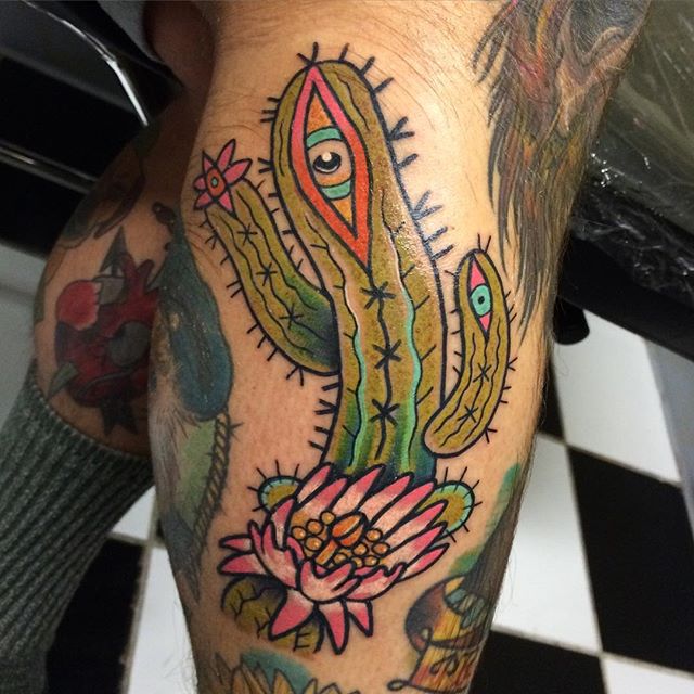 Cactus Having Eyes With Flower Traditional Tattoo On Back Leg