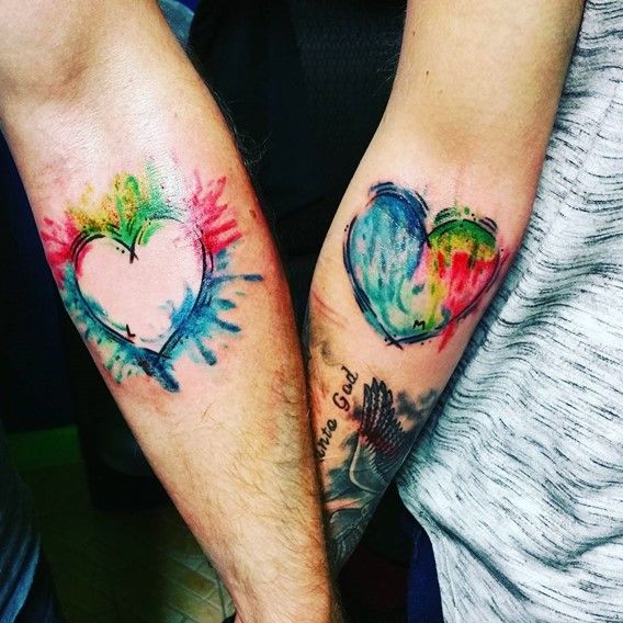 Colorful And Outline Hearts Matching Watercolor Tattoos On Forearms