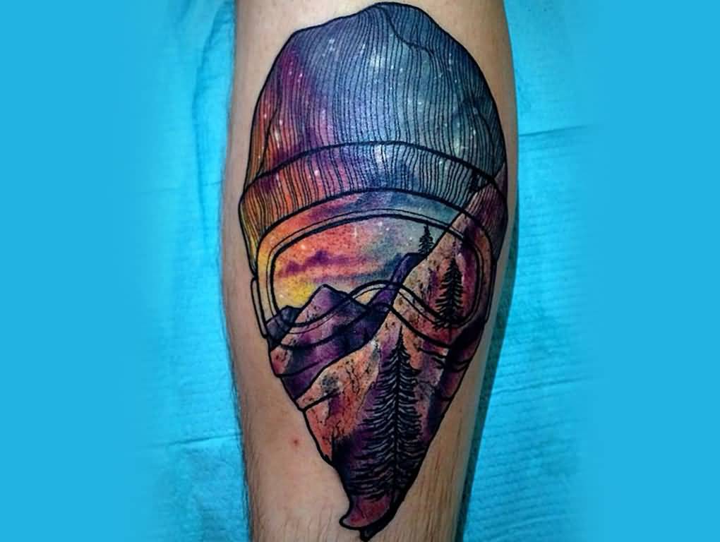 Colorful Mountains And Trees On Snowboarders Face Tattoo