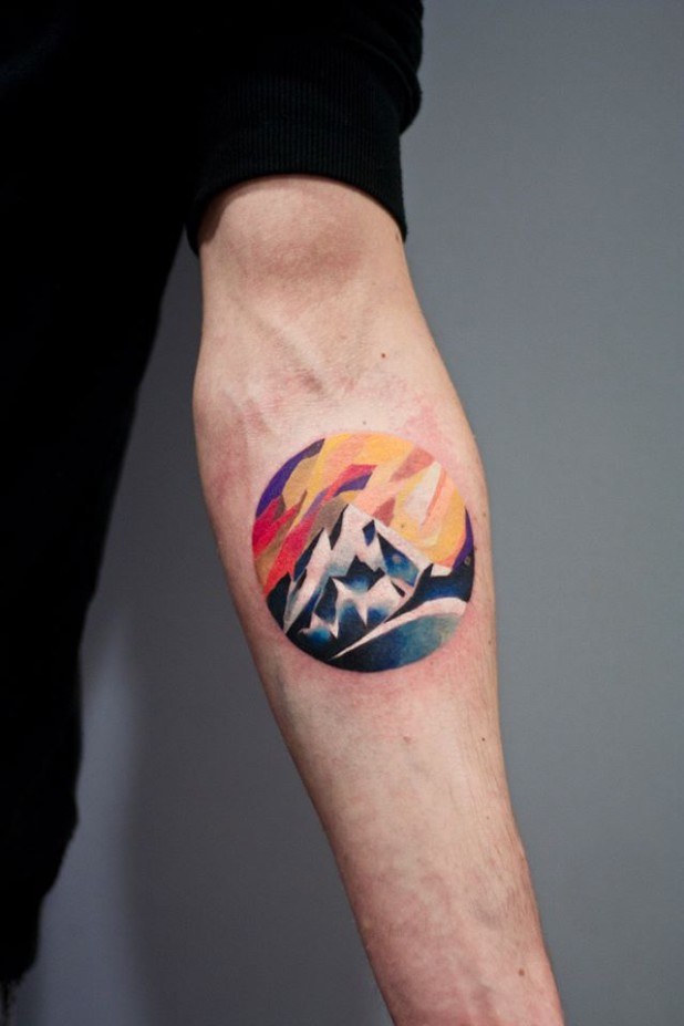 Colorful Mountains In Circle Tattoo On Forearm