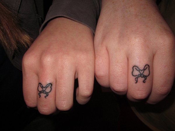Cute And Small Ribbon Matching Tattoos On Fingers