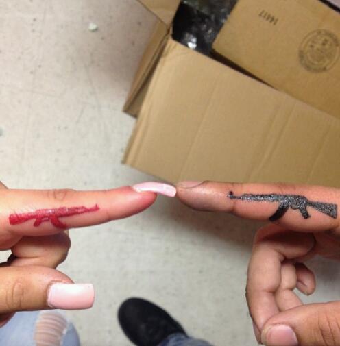 Different Colored Guns Matching Tattoos On Fingers