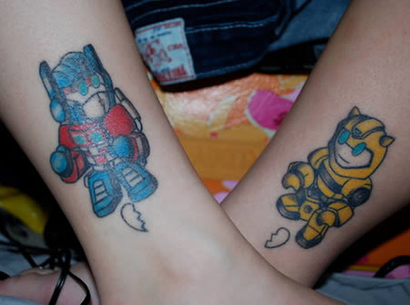 Different Colored Megaman Couple Matching Tattoos On Legs