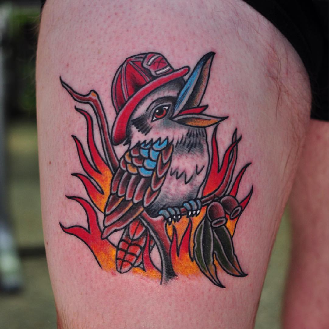 Fireman Kookaburra With Flames Traditional Tattoo On Thigh By Mark Lording