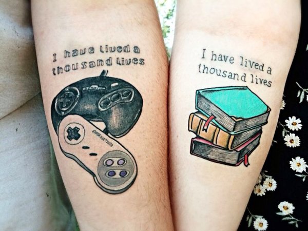 Game Controller With Books And Same Lettering Matching Tattoos On Forearms