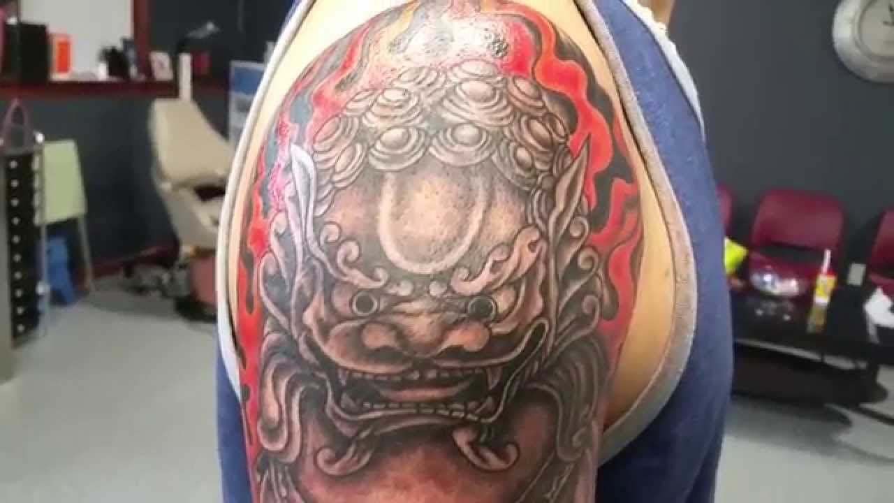Grey Color Foo Dog With Red Background Tattoo On Left shoulder
